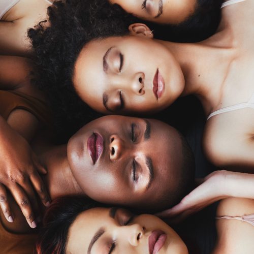High angle shot of a group of beautiful young women lying next to each other